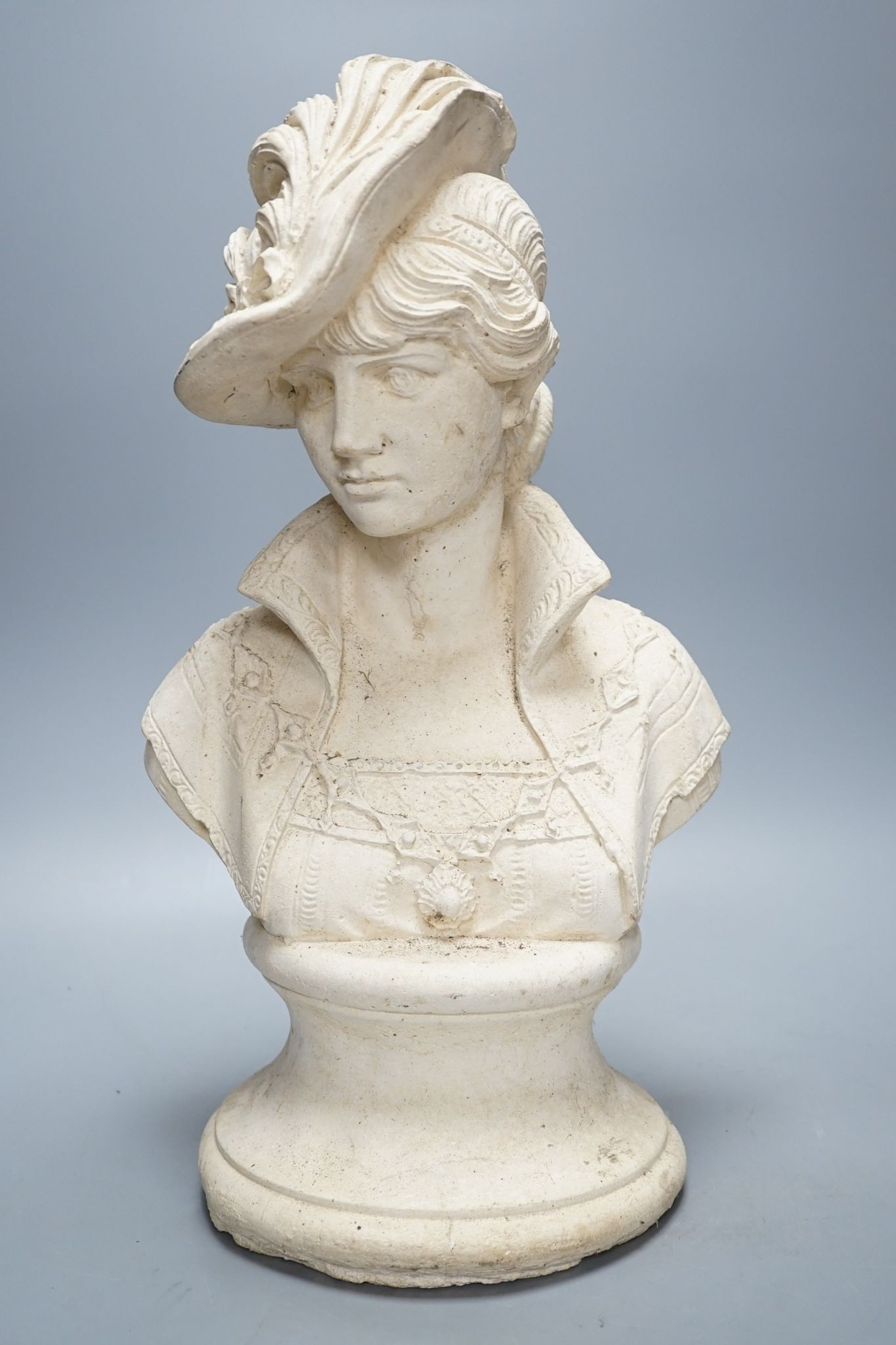 A composition bust of a 19th century lady in feather hat, 47 cms high.